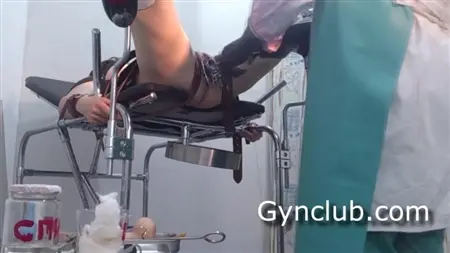 A tied patient in a gynecologist groans when a doctor fingering her pussy